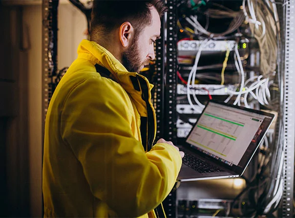 A man testing and maintaning a server stack